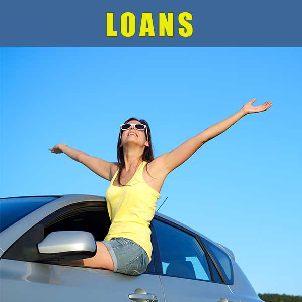 Woman smiling celebrating her new car and a warm sunny day.