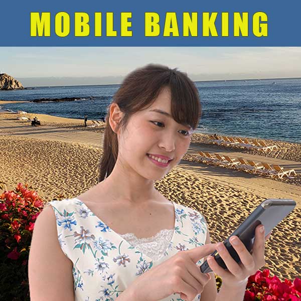 Young woman at the beach doing mobile banking on her phone.