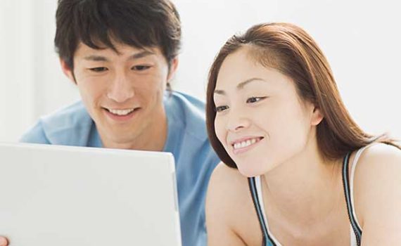 Young couple reviewing their account online.