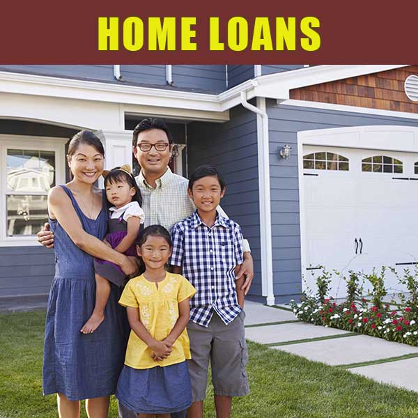 Family of 5 standing and smiling in front of their new home.