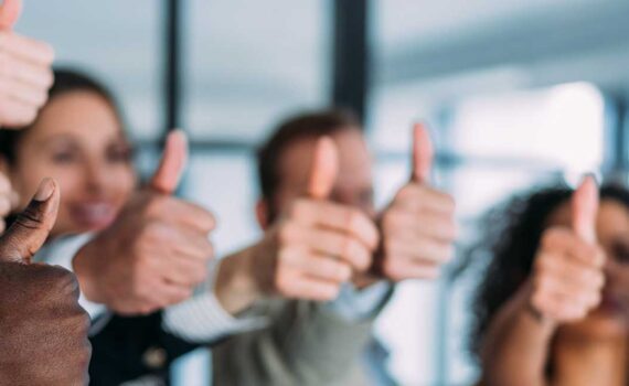 Group of individuals giving the thumbs up sign for the 2023 National JACL Credit Union Annual Meeting on Saturday, April 22nd at 6:00 p.m. at the University of Utah Alumni House.
